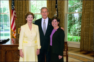 President George W. Bush and Laura Bush congratulate 2003 Maine Teacher of the Year Veronique F. Paquette in the Oval Office Wednesday, April 30, 2003. White House Photo by Eric Draper