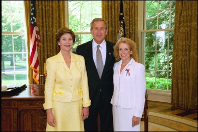 President George W. Bush and Laura Bush congratulate 2003 Maine Teacher of the Year Mary K. Devono in the Oval Office Wednesday, April 30, 2003. White House Photo by Eric Draper