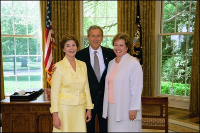 President George W. Bush and Laura Bush congratulate the 2003 National Teacher of the Year Betsy Rogers in the Oval Office Wednesday, April 30, 2003. Rodgers is a 1st and 2nd grade teacher at Leeds Elementary School in Leeds, Ala. White House Photo by Eric Draper