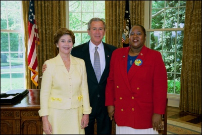 President George W. Bush and Laura Bush congratulate 2003 Maine Teacher of the Year Katherine Wright Knight in the Oval Office Wednesday, April 30, 2003. White House Photo by Eric Draper