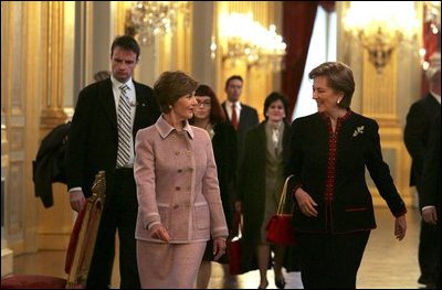 Laura Bush walks with Queen Paola of Belgium during a tour of the Royal Palace of Belgium in Brussels Monday, Feb. 21, 2005.