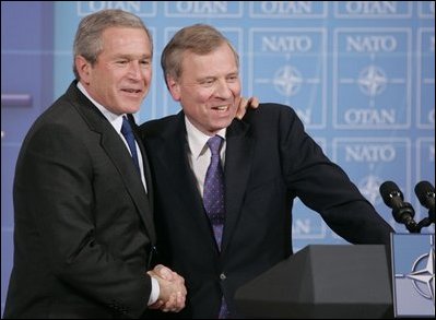 President George W. Bush is welcomed by NATO Secretary General Jaap de Hoop Scheffer during a news conference Tuesday, Feb. 22, 2005, at NATO Headquarters in Brussels.