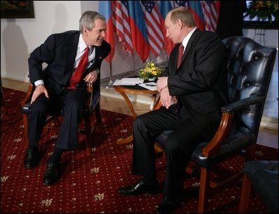 President George W. Bush leans in to speak with Russia President Vladimir Putin Thursday, Feb. 24, 2005 during a photo opportunity in Bratislava, Slovakia. The meeting of the two leaders marked the last during President Bush's five-day European trip.