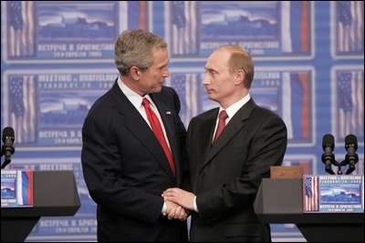 President George W. Bush and Russia President Vladimir Putin clasp hands after a joint news conference Thursday, Feb. 24, 2005, in Bratislava, Slovakia. Said President Bush, "I applaud President Putin for dealing with a country that is in transformation," adding, "It's been hard work."