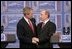 President George W. Bush and Russia President Vladimir Putin clasp hands after a joint news conference Thursday, Feb. 24, 2005, in Bratislava, Slovakia. Said President Bush, "I applaud President Putin for dealing with a country that is in transformation," adding, "It's been hard work."