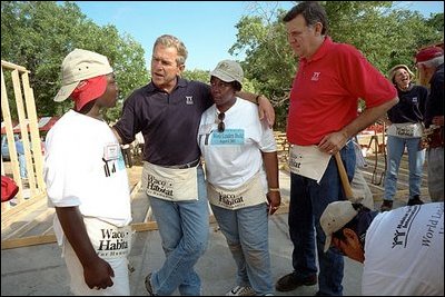 President Bush and Secretary for Housing and Urban Development Martinez, right, talk with new friends during a break from their house-building efforts at the Waco, Texas, location of Habitat for Humanity's "World Leaders Build" construction drive August 8, 2001. 