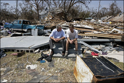 President George W. Bush spends a moment with a Patrick Wright during his walking tour Friday, Sept. 2, 2005, of Biloxi, Miss. "You know, there's a lot of sadness, of course," said the President of the devastated area. "But there's also a spirit here in Mississippi that is uplifting."