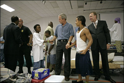 President George W. Bush visits with children inside the Bethany World Prayer Center shelter, Monday, Sept. 5, 2005 in Baton Rouge, Louisiana. The facility is housing hundreds of people displaced by Hurricane Katrina.