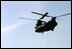 Helicopters lift sandbags that will be dropped into the area of the levee break to facilitate repairs to 17th street levee in New Orleans, Louisiana Thursday, September 8, 2005.