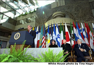 "Today, I call for a new compact for global development, defined by new accountability for both rich and poor nations alike," states President George W. Bush in his address at the Inter-American Development Bank in Washington, D.C. March 14. Accompanying the President from left to right are: the lead singer of U2, Bono; Cardinal McCarrick and Worldbank President Jim Wolfensohn.