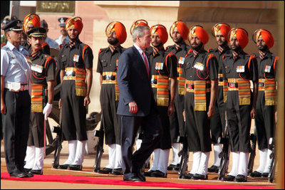 President George W. Bush participates in the troop review Thursday, March 2, 2006, during the arrival ceremony at Rashtrapati Bhavan in New Delhi.