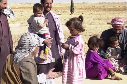 Children in the local area enjoy candy that was given to them by soldiers.