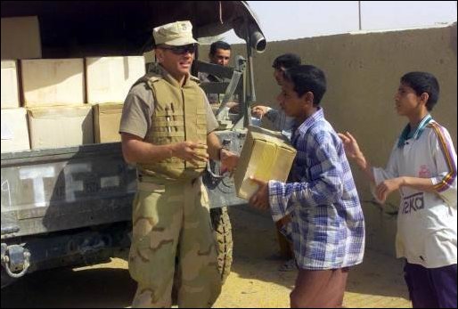 Task Force Tarawa Marines offloading food supplies for use by the Iraqi citizens.