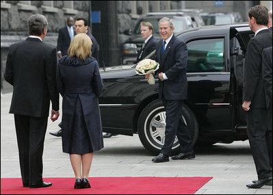 President George W. Bush carries a bouquet of flowers on his arrival to meet President Viktor Yushchenko of Ukraine, and his wife, Mrs. Kateryna Yushchenko Tuesday, April 1, 2008, at the Presidential Secretariat in Kyiv for their welcoming ceremony.
