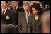 President George W. Bush bows his head as he stands with Secretary of State Condoleezza Rice Thursday, April 3, 2008, at the start of the North Atlantic Council Summit in Bucharest.