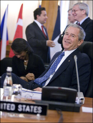 President George W. Bush smiles at photographers as they gather in front of him Friday, April 4, 2008, during the afternoon session of the 2008 NATO Summit in Bucharest.