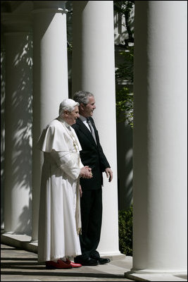 President George W. Bush and Pope Benedict XVI look out onto the Rose Garden from the Colonnade of the White House before their meeting Wednesday, April 16, 2008. The visit of Pope Benedict XVI is the first White House papal visit in three decades.