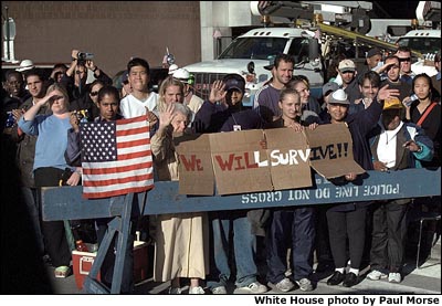Photo of New Yorkers holding an American flag and a sign that says "Survivors." White House photo by Paul Morse.