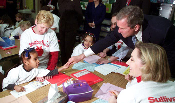 President George W. Bush greets a student at Sullivant Elementary School in Columbus Ohio on February 20, 2001. The president traveled to the school to emphasize accountability of school for the quality of education they provide. White House Photo by Paul Morse