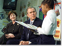 President George W. Bush and the First Lady Laura Bush listen to student Janea Bufford read at Moline Elementary School in St.Louis, Missouri on February 20 2001. (White House Photo by Paul Morse)