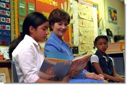 Laura Bush listens as a student at Caesar Chavez Elementary School reads during a “Ready to Read Ready to Learn” visit to the school in Hyattsville, Maryland, Feb., 26, 2001.  
