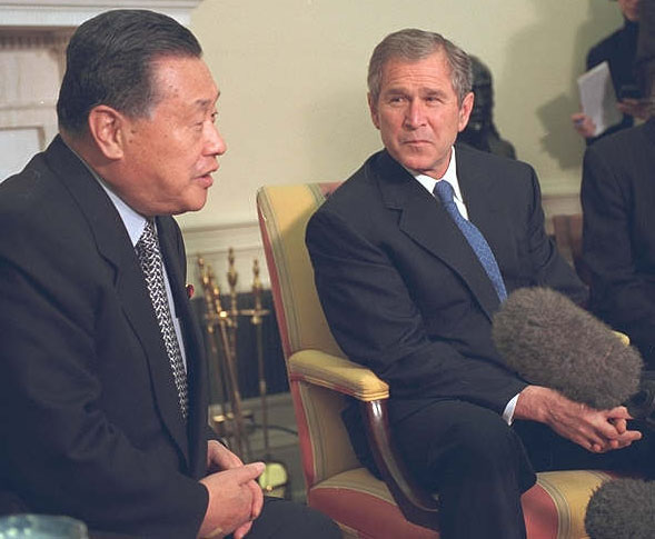President Bush listens to Prime Minister Yoshiro Mori during a meeting in the Oval Office.