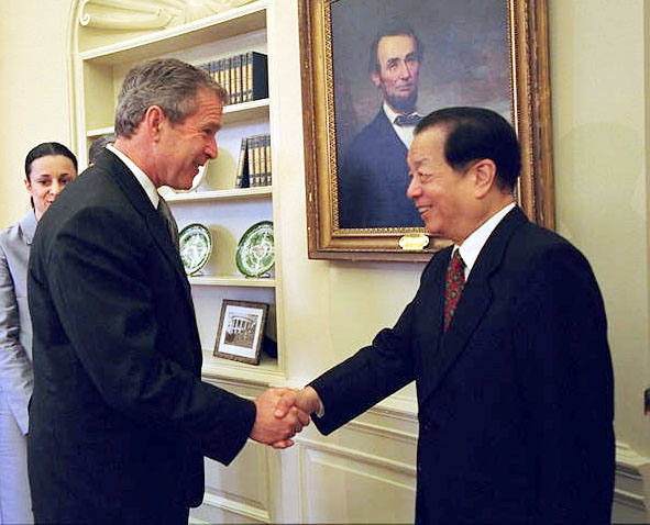 Photograph of President Bush shaking hands with Vice Premier of China Qian Qichen. 