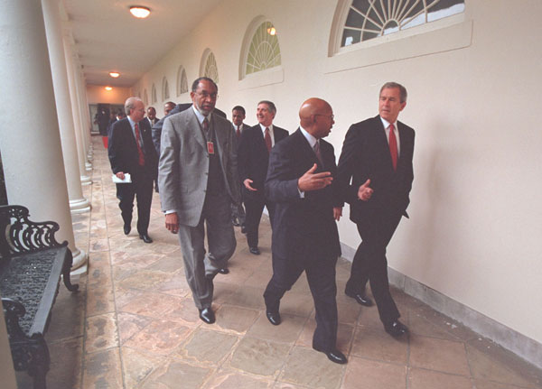 President George W. Bush escorts African American leaders through the Collonade before his speech to African American leaders in the East Room, Thursday, March 29.