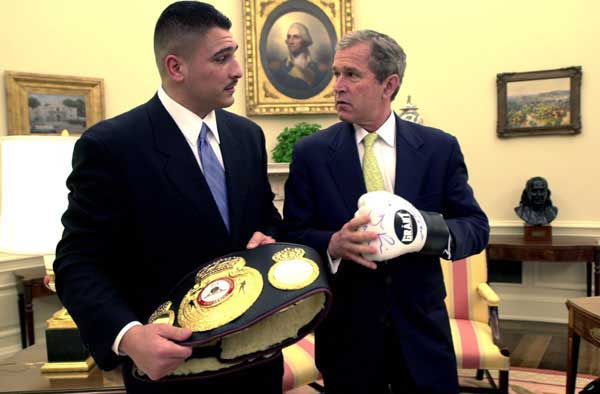 President George W. Bush and Boxer Johnny Ruiz look at a boxing glove and the World Boxing Association Heavyweight Championship belt inside the Oval Office, Thursday, March 15.
