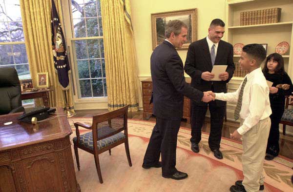 President George W. Bush meets the 11-year-old Johnny, son of boxer Johnny Ruiz, center, inside the Oval Office, Thursday, March 15. Also pictured is Ruiz daughter, Jocelyn, age 8.