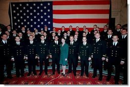Mrs. Bush poses with the members of the U.S. Naval Academy Men’s Glee Club during the Senate Spouses luncheon at the U.S. Capitol April 3, 2001.  White House photo by Susan Sterner