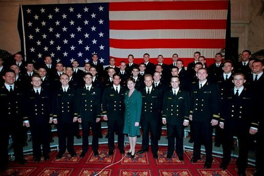 Mrs. Bush poses with the members of the U.S. Naval Academy Men’s Glee Club during the Senate Spouses luncheon at the U.S. Capitol April 3, 2001. White House photo by Susan Sterner.