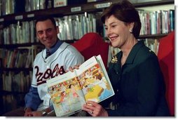 Laura Bush and Baltimore Orioles shortstop, Mike Bordick, read to children at the Washington, D.C. Public Library, Northeast Branch, as part of “Celebrate National Library Week at your Library” April 3, 2001.  White House photo by Eric Draper