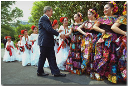 President George W. Bush greets dancers before their performance during Cinco De Mayo festivities at the White House Friday, May 4. WHITE HOUSE PHOTO BY ERIC DRAPER