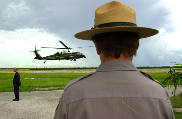 Marine One lands with President George W. Bush at Daniel Beard Center in Everglades National Park as Maureen Finnerty, Superintendent of Everglades National Park watches (Monday June 4). WHITE HOUSE PHOTO BY ERIC DRAPER