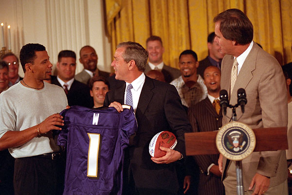 President George W. Bush accepts a jersey and football from the NFL Champion Baltimore Ravens on Thursday, June 8 at the White House. White House photo by Susan Sterner.