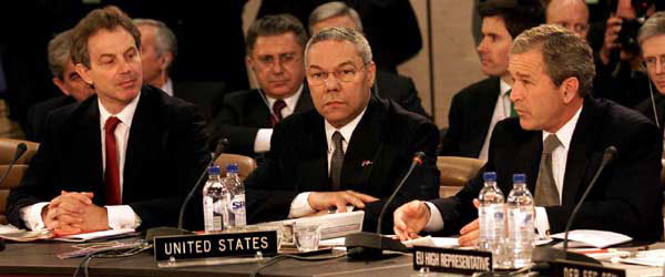 President George W. Bush speaks with Secretary of State Colin Powell, center and British Prime Minister Tony Blair at the Secretary General’s office at NATO headquarters in Brussels, Belgium on June 13, 2001. WHITE HOUSE PHOTO BY PAUL MORSE