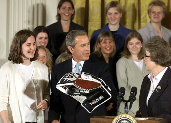 President George W. Bush holds a goalie glove with the team captain Brittny Ralph, left, and Chancellor Kathryn Martin of the Minnesota-Duluth 2001 NCAA Women’s Hockey Champions Monday, June 25, 2001. WHITE HOUSE PHOTO BY PAUL MORSE