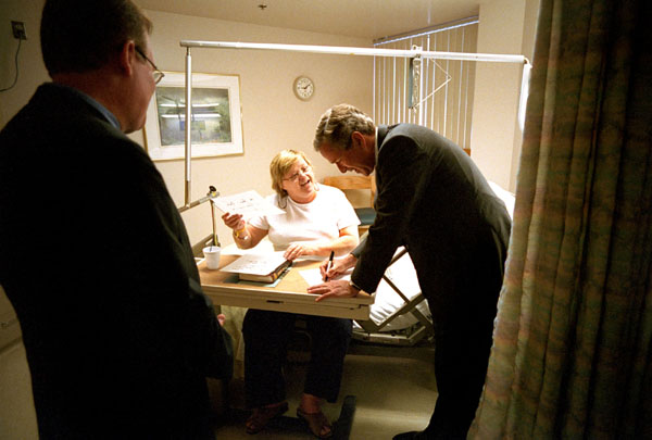 While addressing the upcoming patients' bill of rights legislation, President Bush gets a little practice signing his name while meeting patients at Inova Fair Oaks Hospital in Fairfax, VA, July 9, 2001. 