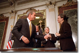 President Bush greets Nancy Coverdell after signing in honor of her husband, Paul Coverdell, a former director of the Peace Corps, Thursday, July 26, 2001. 
