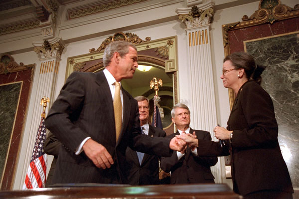President Bush greets Nancy Coverdell after signing in honor of her husband, Paul Coverdell, a former director of the Peace Corps, Thursday, July 26, 2001. White House photo by Eric Draper.