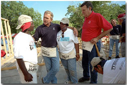President Bush and Secretary for Housing and Urban Development Martinez, far right, talk with new friends during a break from their house-building efforts at the Waco, Texas, location of Habitat for Humanity's "World Leaders Build" construction drive August 8, 2001. White House photo by Eric Draper.