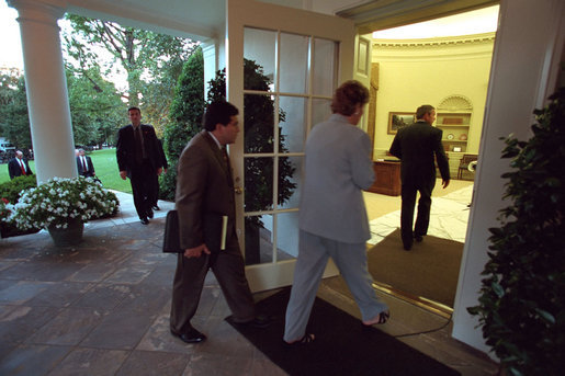 President George W. Bush returns to the White House followed by White House Counsel Alberto Gonzales and Counselor Karen Hughes Sept. 11, 2001. White House photo by Eric Draper