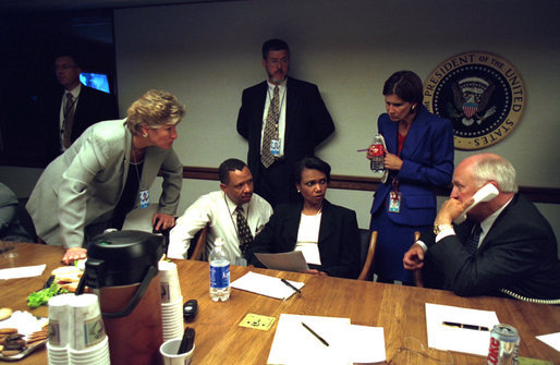 Vice President Dick Cheney talks with President Bush as senior staff listen from the Presidential Emergency Operations Center Sept. 11, 2001. White House photo by Eric Draper