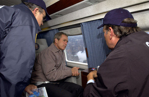 President George W. Bush tours the World Trade Center disaster site aboard Marine One with New York Mayor Rudolph Giuliani, left, and New York Governor George Pataki, Friday, Sept. 14, 2001. White House photo by Eric Draper