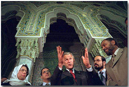 After addressing the media, President George Bush talks with his hosts during his visit to the Islamic Center of Washington, D.C. Sept. 17, 2001. "And it is my honor to be meeting with leaders who feel just the same way I do. They're outraged, they're sad," said the President during his remarks. "They love America just as much as I do.". White House photo by Eric Draper.