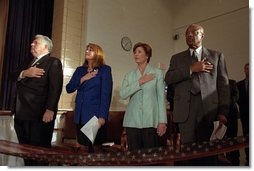 Laura Bush listens to the National Anthem with Bill and Elayne Bennett, left, and Secretary of Education Rod Paige, right, during a Best Friends for Our Children Event at Bertie Backus Middle School Nov. 7, 2001 in Washington, D.C.  White House photo by Susan Sterner
