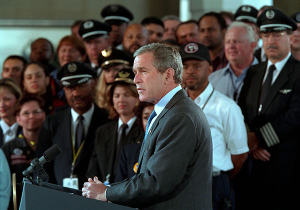 President George W. Bush addresses the audience at the Signing of Aviation Security Legislation at Ronald Reagan National Airport Nov. 19. in Washington, D. C. "The broad support for this bill shows that our country is united in this crisis," said the President." We have our political differences, but we're united to defend our country. And we're united to protect our people.". White House photo by Paul Morse.