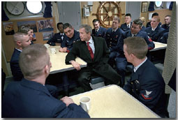 Sitting in the small mess hall decorated with pictures from New York, President George W. Bush takes time to talk during his tour of the United States Coast Guard Cutter Tahoma in Portland, Maine, Jan. 25. White House photo by Eric Draper.