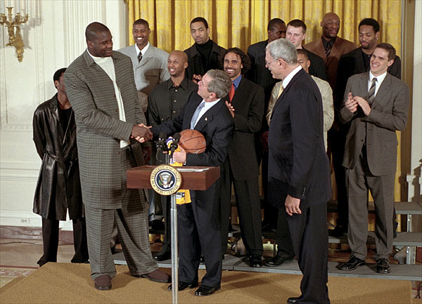 President George W. Bush checks out the air up there as he welcomes Shaquille O'Neal and the rest of NBA Champion Los Angeles Lakers in the East Room Jan. 28. "Being champs on the court means you've got to be champs off the court, as well," said the President. "And I know these players understand that every time they do something, some kid is watching. Every time they say something, some kid is listening. And I want to thank the players who understand that with victory comes huge responsibility, to encourage people to make the right choices in life." White House photo by Tina Hager.
